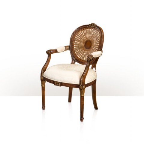 A hand carved and gilt armchair with a caned spoon back